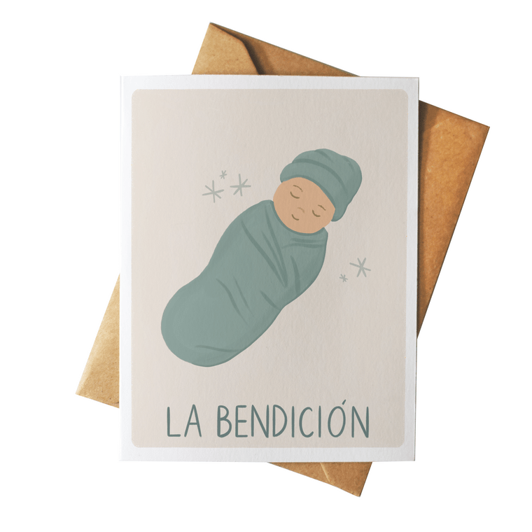Greeting card with a baby illustration and 'La Bendicion' text on a beige background with a brown envelope.