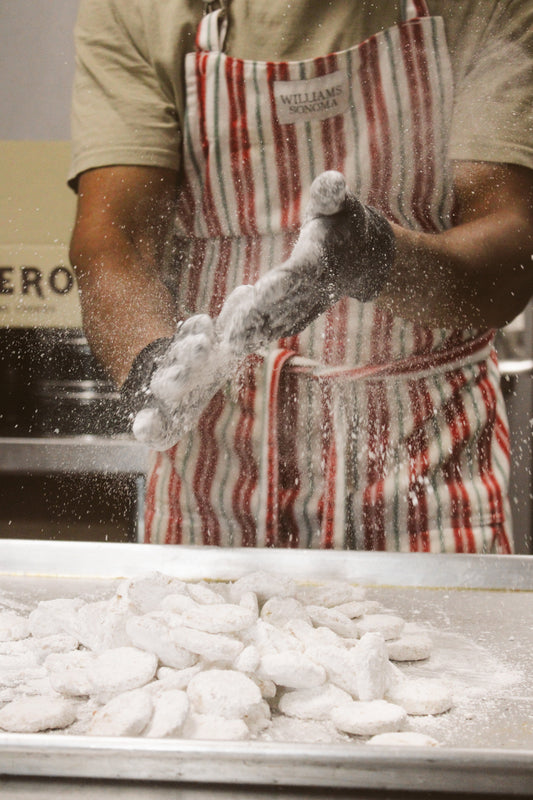 person tying on a red and white striped apron