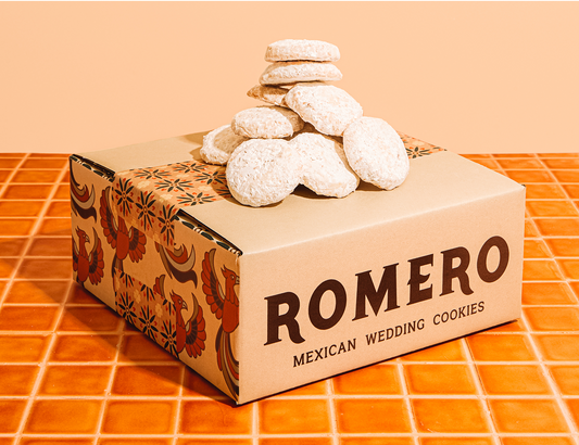 mexican wedding cookies piled on a decorative box