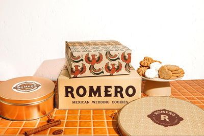 romero pacakging in front of a white backdrop and orange tile