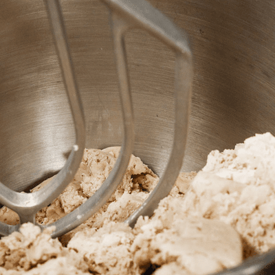 mexican wedding cookies in the making (a mixer creaming butter and sugar)