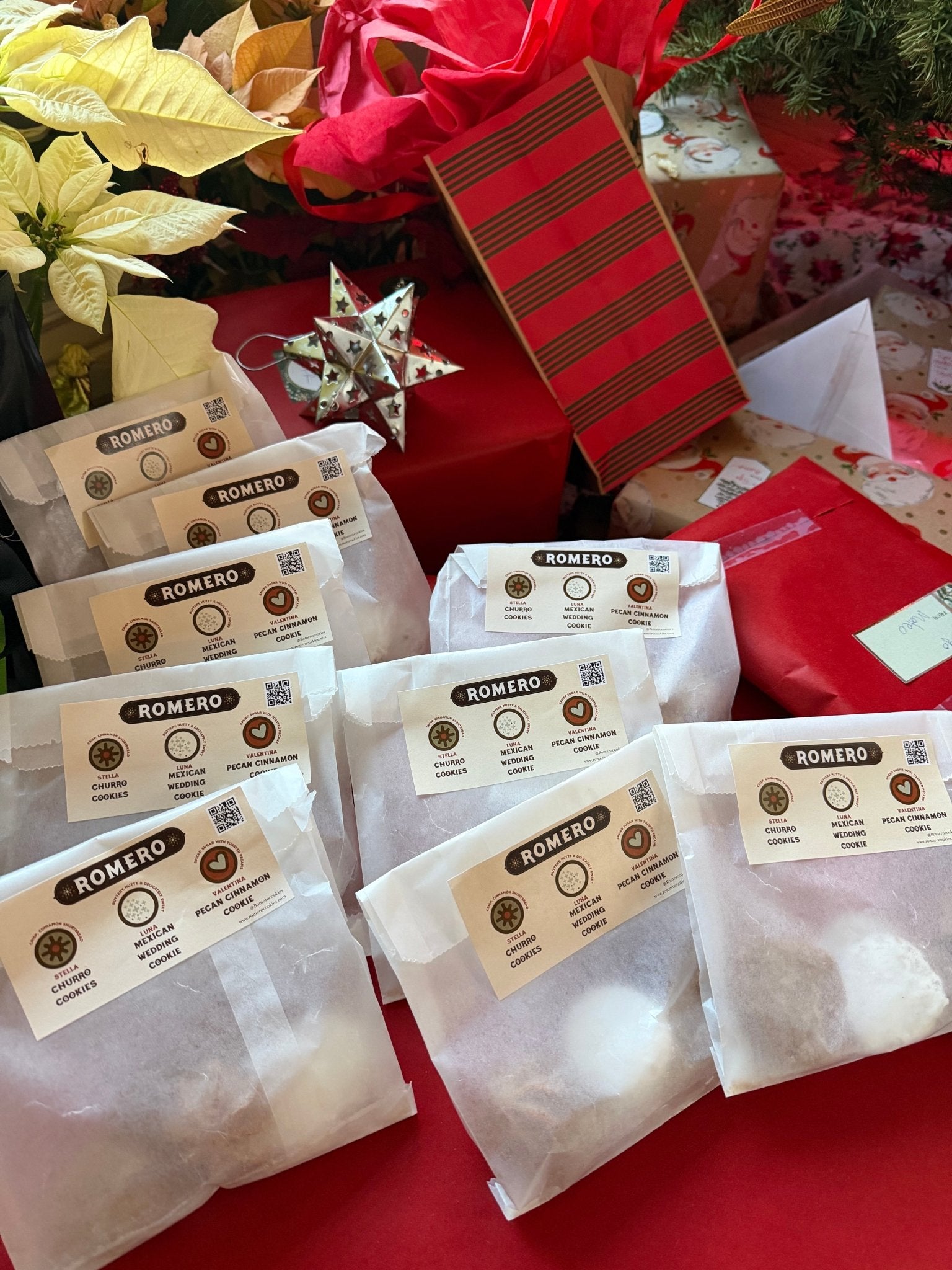 cookies in wax paper bags with poinsettia background