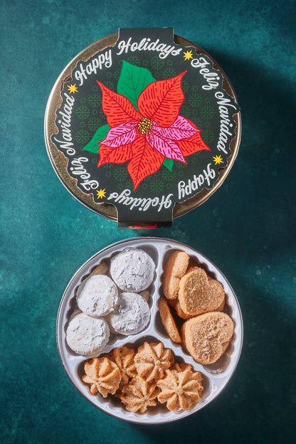 poinsettia paper band against dark green background with open cookie tin showing a variety of mexican cookies