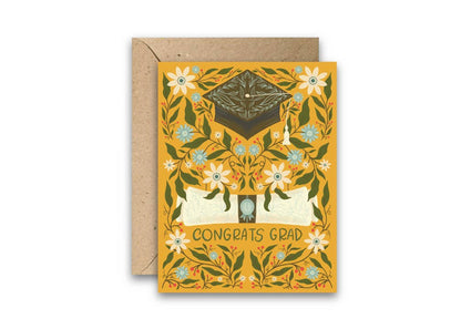 Graduation card with decorative design and 'Congrats Grad' text on a white background