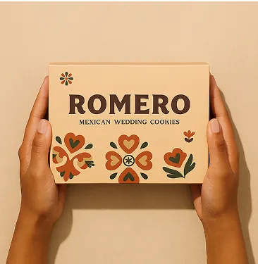 Hands holding a Romero cookie gift box