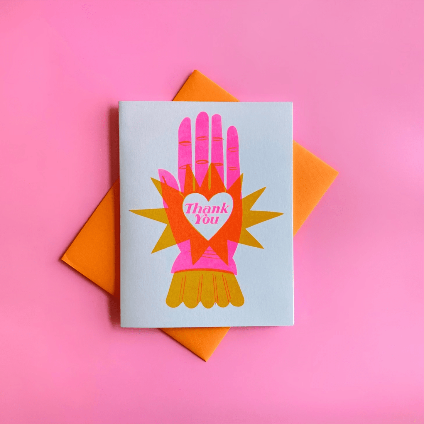 Greeting card with colorful hand design and 'Thank You' message on a pink background