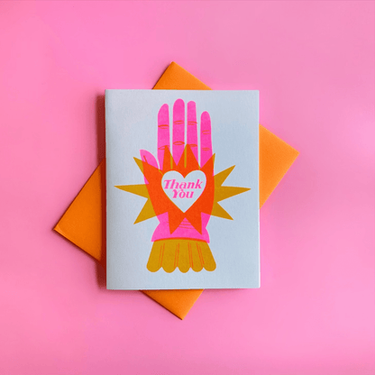 Greeting card with colorful hand design and 'Thank You' message on a pink background