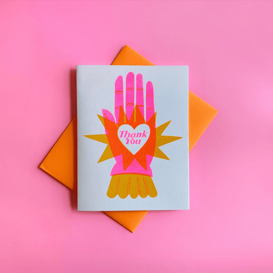 Greeting card with colorful hand design and 'Thank You' message on a pink background
