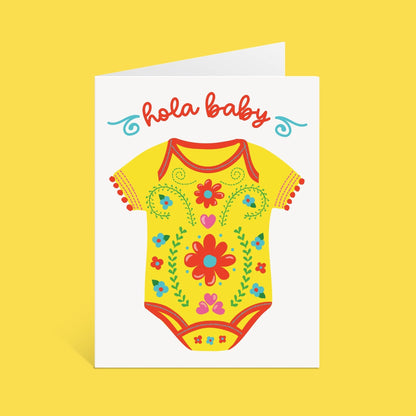 Greeting card with a yellow baby onesie illustration and 'Hola Baby' text on a yellow background