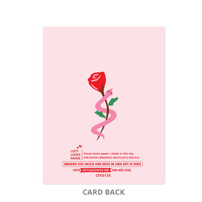 Card back with a red rose and pink snake design on a light pink background, featuring Lucy Loves Paper branding.