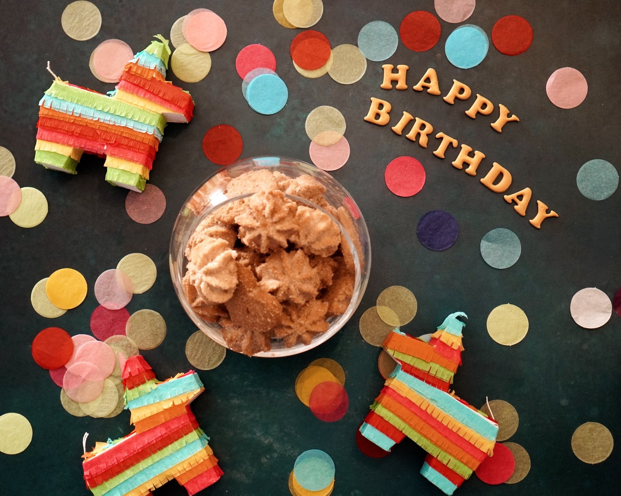 Mexican heritage cookies styled with papel picado confetti, traditional fiesta cookie gift assortment