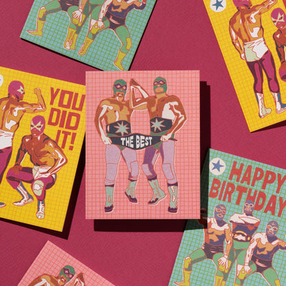 Colorful greeting cards with superhero designs on a pink background