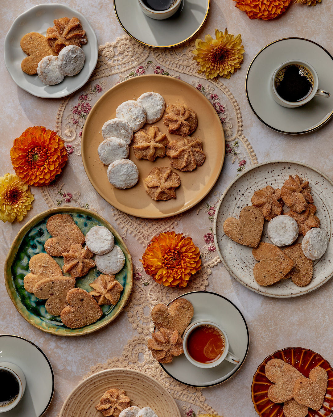 cookies on a table setting with coffee and flowers