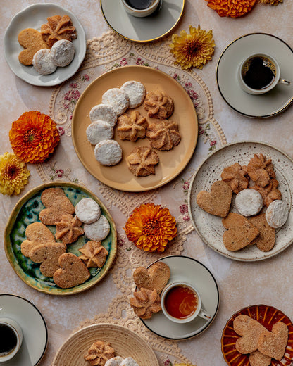 cookies on a table setting with coffee and flowers