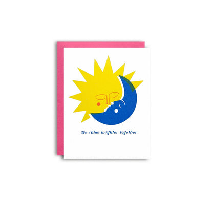 Card with sun and moon design and text 'We shine brighter together' on a white background